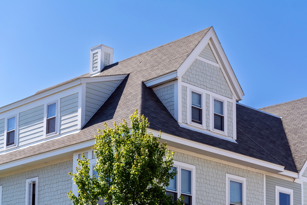Dormer,windows,on,the,sloped,shingle,roof,of,a,newly